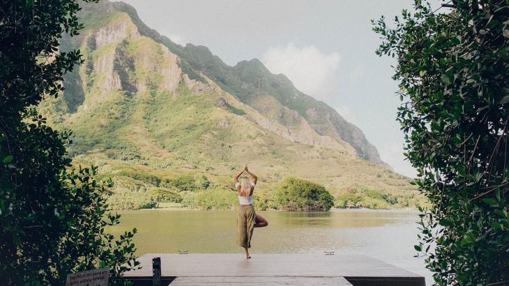 A person doing yoga poses outside